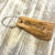 Engraved driftwood keyrings as place settings and favours - your guests receive a personalised driftwood keyring to take home