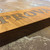 Stainless steel lettering inlaid into solid oak sign.