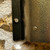 Close up of the antique gold with black flecked light surround sconce with personalised number.
