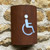 Corten steel curved light with disabled toilet symbol