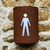 Corten steel curved light with mens toilet symbol