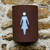 Corten steel curved light with women's / ladies toilet symbol