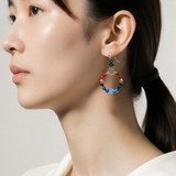 modeling hoop rainbow earrings designed especially for pride month.  rainbow hoop earrings are sterling silver with swarovski crystals by designer karen curtis