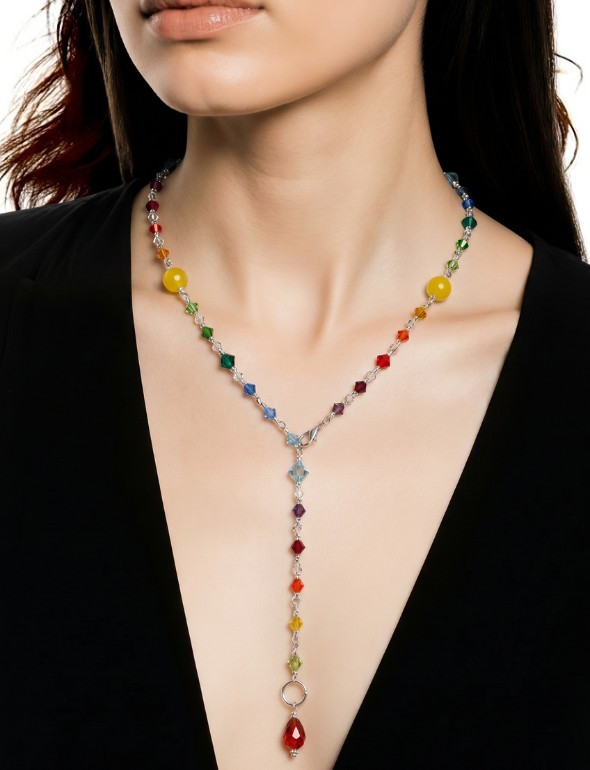 curtis wearing rainbow pride hoop earrings with rainbow necklace designed for pride month. wearing as a y necklace in image.