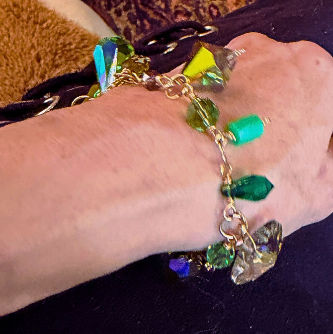 me wearing the charm bracelet - very accurate for color and scale -  I have a 5.5" wrist - made to be adjustable so to fit your wrist