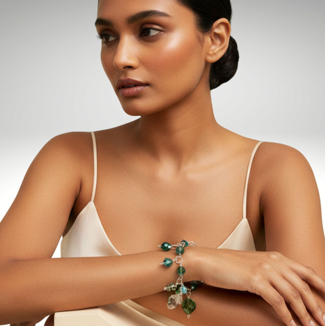 different view on model wearing limited edition charm bracelet featuring rare vintage swarovski crystals, 14k gold filled metal - greens, special effect crystals and bronze