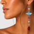 dramatic geometric shoulder duster earrings on model close up