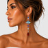 dramatic geometric shoulder duster earrings on model