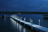 Solar dock post light glowing on a dock with calm water