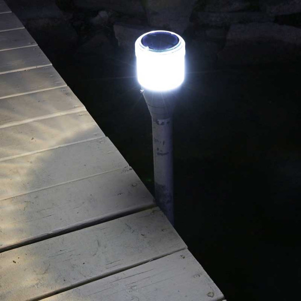 Close-up of a solar dock post light on a wooden dock