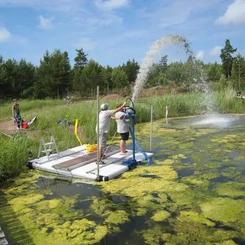Portable suction dredge removing sediment from a pond while mounted to a floating platform