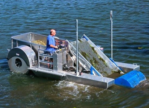 Eco-Harvester aquatic weed harvesting boat pulling and collecting lake weeds