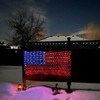 The picture portrays a captivating scene of a Solar LED 6.5' USA Net Flag hung on a fence in a snowy yard, illuminated by the soft glow of a full moon. The flag stands tall and proud, showcasing the iconic stars and stripes of the American flag.

Against the backdrop of the snowy landscape, the flag creates a striking contrast with its vibrant colors and the warm illumination of the solar-powered LED lights. The snowy yard adds a touch of serenity and tranquility to the scene, evoking a sense of winter magic.

The full moon casts a soft and ethereal light, enhancing the beauty of the flag and creating a mesmerizing ambiance. The combination of the illuminated flag, snowy surroundings, and the moonlit sky evokes a sense of patriotism and peacefulness.

The picture captures the essence of the Solar LED 6.5' USA Net Flag in a snowy setting, inviting viewers to appreciate the beauty of the flag's design, the enchantment of the snowy landscape, and the celestial presence of the full moon. It is a visual representation of the patriotic spirit and the magical atmosphere that winter brings.