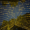 A stunning 10' x 30' warm white LED light curtain is gracefully displayed, with 3,600 tiny glowing lights cascading down in evenly spaced rows. The warm white light creates a soft, inviting ambiance, ideal for festive events or cozy décor. The expansive size provides a dramatic effect, covering a large walls, windows, or outdoor spaces. The gentle glow of the LEDs beautifully illuminates the surroundings, offering a magical, twinkling backdrop perfect for any occasion.