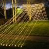 A stunning 10' x 30' warm white LED light curtain is gracefully displayed, with 3,600 tiny glowing lights cascading down in evenly spaced rows. The warm white light creates a soft, inviting ambiance, ideal for festive events or cozy décor. The expansive size provides a dramatic effect, covering a large walls, windows, or outdoor spaces. The gentle glow of the LEDs beautifully illuminates the surroundings, offering a magical, twinkling backdrop perfect for any occasion.