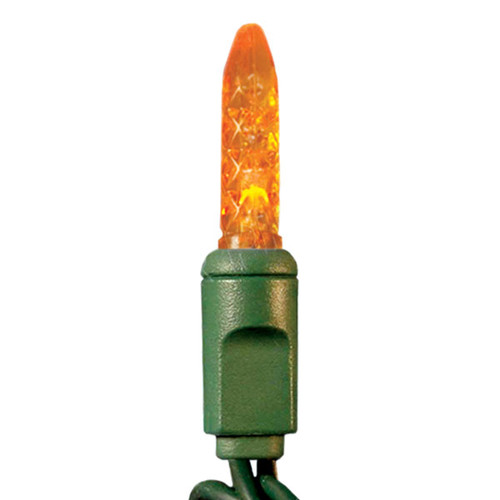 This image shows an orange LED mini light with a faceted tip, commonly used for holiday or decorative lighting. The bulb is mounted in a green socket and connected to a green wire string, designed for indoor or outdoor use. This image shows an orange LED mini light with a faceted tip, commonly used for holiday or decorative lighting. The bulb is mounted in a green socket and connected to a green wire string, designed for indoor or outdoor use.