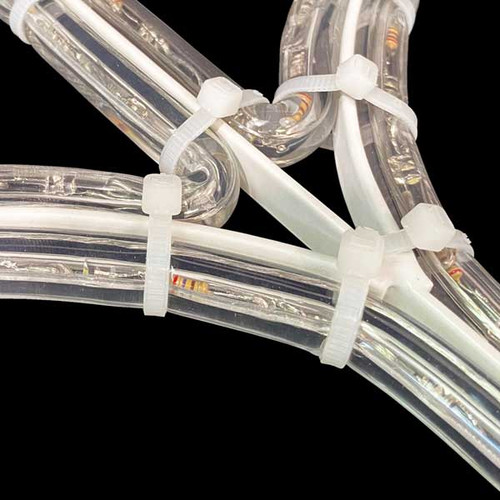 In this close-up photo, we explore the meticulous details of the assembly process, revealing the connection between white rope light material, LED lights, and a sturdy metal frame. The image focuses on the zip ties that securely fasten the rope light material and lights to the frame, ensuring a stable and seamless display. The zip ties, with their slender yet robust design, elegantly intertwine with the components, holding everything in place with precision and durability. This close-up perspective highlights the craftsmanship and attention to detail involved in creating a cohesive and professionally executed arrangement. The combination of white rope light material, radiant LED lights, and the sturdy metal frame showcases the intricate artistry that brings forth a stunning and reliable lighting installation. In this close-up photo, we explore the meticulous details of the assembly process, revealing the connection between white rope light material, LED lights, and a sturdy metal frame. The image focuses on the zip ties that securely fasten the rope light material and lights to the frame, ensuring a stable and seamless display. The zip ties, with their slender yet robust design, elegantly intertwine with the components, holding everything in place with precision and durability. This close-up perspective highlights the craftsmanship and attention to detail involved in creating a cohesive and professionally executed arrangement. The combination of white rope light material, radiant LED lights, and the sturdy metal frame showcases the intricate artistry that brings forth a stunning and reliable lighting installation.