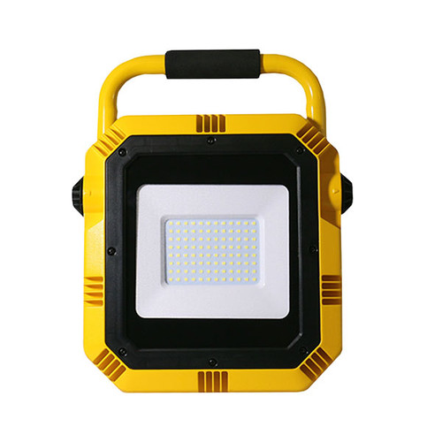 A front-facing view of a yellow portable LED work light. The light features a square black frame with a recessed white panel in the center containing a grid of small LED bulbs. The unit has a yellow body with black grip padding on the top carrying handle. The corners and sides have angular ridges for durability and heat dissipation, giving it a rugged, industrial design. A front-facing view of a yellow portable LED work light. The light features a square black frame with a recessed white panel in the center containing a grid of small LED bulbs. The unit has a yellow body with black grip padding on the top carrying handle. The corners and sides have angular ridges for durability and heat dissipation, giving it a rugged, industrial design.