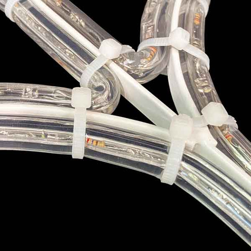 In this close-up photo, we explore the meticulous details of the assembly process, revealing the connection between white rope light material, LED lights, and a sturdy metal frame. The image focuses on the zip ties that securely fasten the rope light material and lights to the frame, ensuring a stable and seamless display. The zip ties, with their slender yet robust design, elegantly intertwine with the components, holding everything in place with precision and durability. This close-up perspective highlights the craftsmanship and attention to detail involved in creating a cohesive and professionally executed arrangement. The combination of white rope light material, radiant LED lights, and the sturdy metal frame showcases the intricate artistry that brings forth a stunning and reliable lighting installation. In this close-up photo, we explore the meticulous details of the assembly process, revealing the connection between white rope light material, LED lights, and a sturdy metal frame. The image focuses on the zip ties that securely fasten the rope light material and lights to the frame, ensuring a stable and seamless display. The zip ties, with their slender yet robust design, elegantly intertwine with the components, holding everything in place with precision and durability. This close-up perspective highlights the craftsmanship and attention to detail involved in creating a cohesive and professionally executed arrangement. The combination of white rope light material, radiant LED lights, and the sturdy metal frame showcases the intricate artistry that brings forth a stunning and reliable lighting installation.