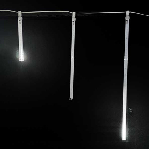 6-piece LED Snowfall Tubes Set in three different lengths—12", 24", and 36". Each tube is sleek and transparent, filled with bright, cool white or warm white LED lights that give the appearance of falling snowflakes.