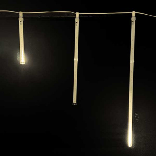 6-piece LED Snowfall Tubes Set in three different lengths—12", 24", and 36". Each tube is sleek and transparent, filled with bright, cool white or warm white LED lights that give the appearance of falling snowflakes.