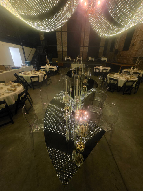 A picture of a reflection of the drapped swag lighting off the ceiling.    This reflection creates a sea of small lights that dance like stars in the night.  The lighting is very balanced and not to bright.