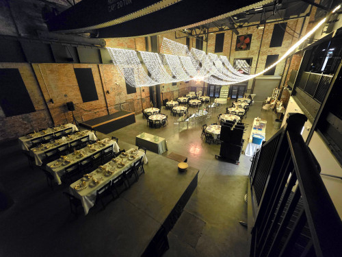 Picture of an elegant evening affair complete with beautifully set tables.   The drapped swag lighting in the ceiling gives off vibes of classiness and elgance.  Anyone looking to decorate for a corprate event or wedding would love this picture.