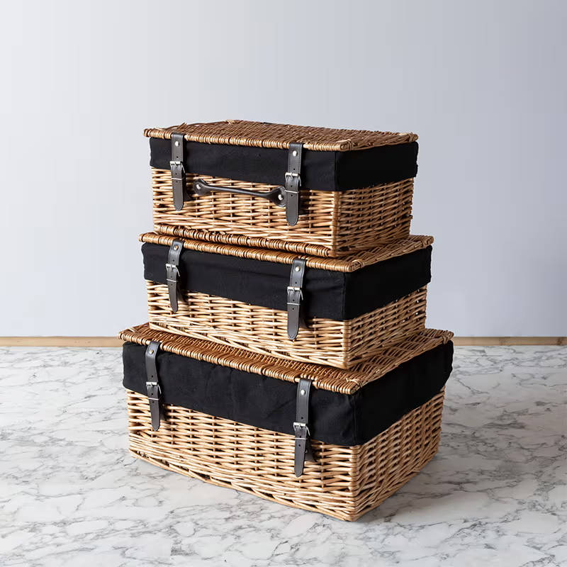 Three wicker baskets on top of each other, largest to smallest with additional material around the top