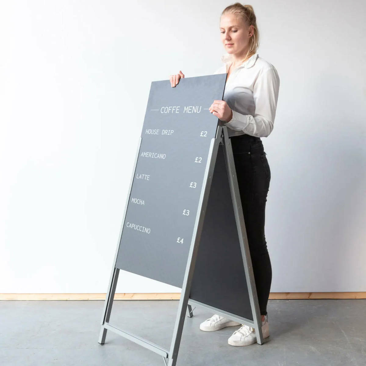 A person slotting a board into an A Frame