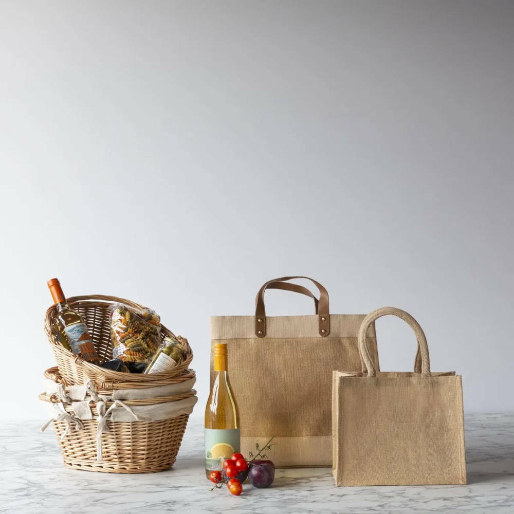 Two bags on a marble surface with three baskets held within each other