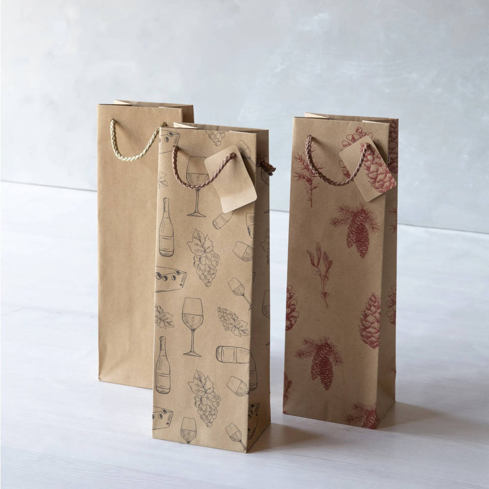 Three brown bottle bags on a white wooden table