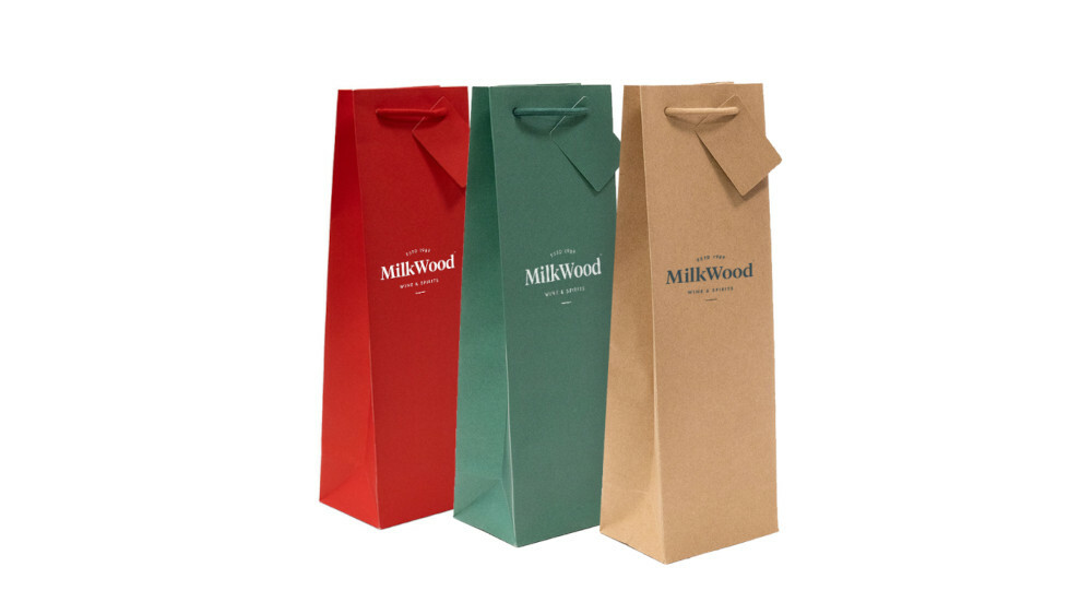 Three different colour bags lined up, red to green to natural