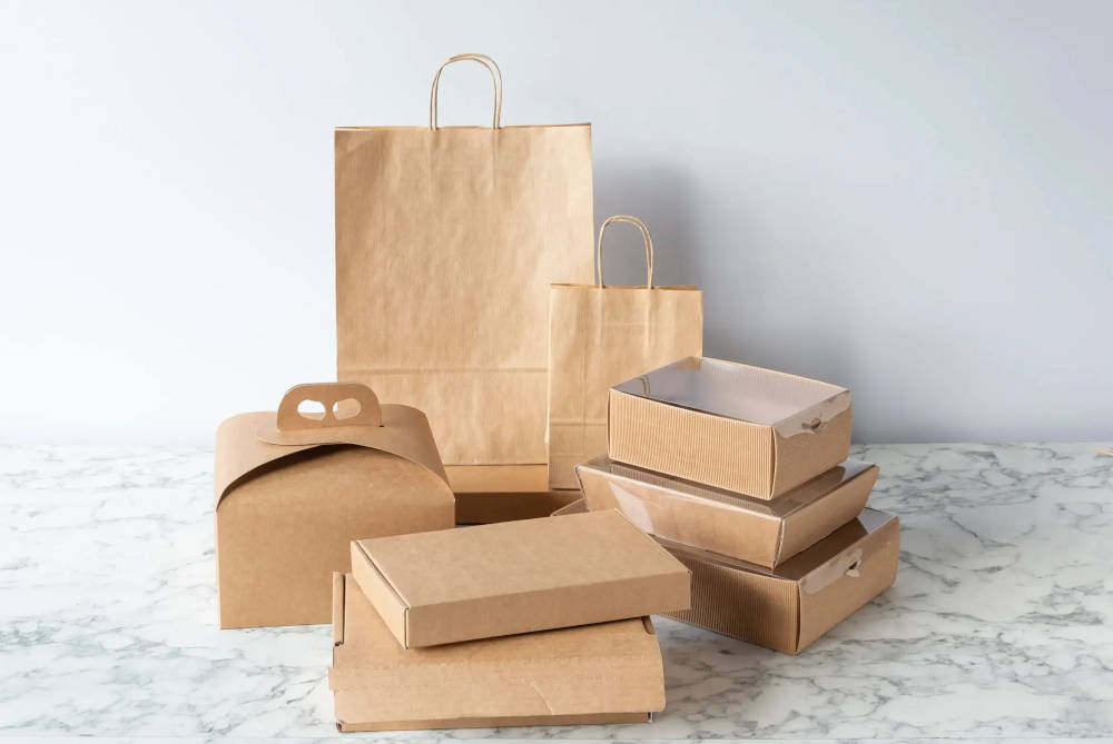 Two paper bags and other small boxes on a marble table