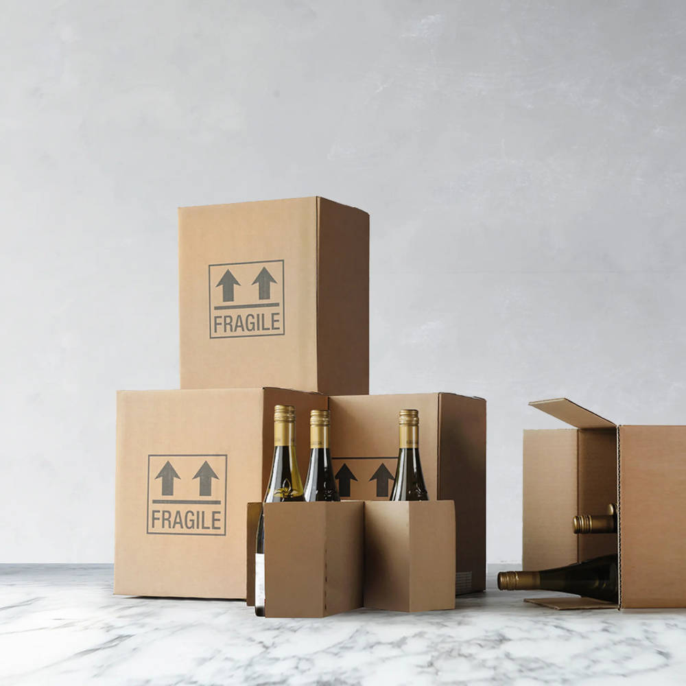 Boxes with Fragile written on them and some wine bottles standing up and on their side