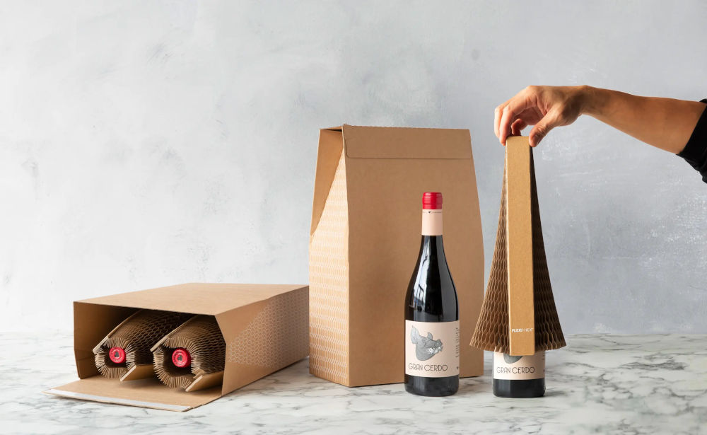 Four wine bottles being stored in boxes with a hexagon shaped protective layer around them