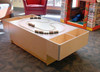 Playscapes 3-Branch Discovery Train Track Table, wooden train table with three-branch train track and toy train set, in children's play area.