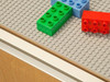 Playscapes 3-Branch Discovery Lego Table, colorful Lego bricks on a gray baseplate.