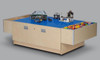 Playscapes 3-Branch Discovery Lego Table, a large wooden table with a blue LEGO surface featuring various LEGO structures and toys for children's creative play.