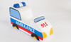 Novum Ambulance Ride On Toy, children's toy ambulance with white body, blue and red emergency stripes, yellow headlights, and a blue emergency light on top.