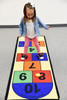 Learning Carpets Hopscotch Play Carpet, a young girl playing on a colorful educational hopscotch rug.