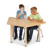Jonti-Craft See-Thru Table Divider Shields - 2 Station, clear acrylic protective barrier on a light wooden table separating two children sitting across from each other.