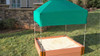 Frame It All Square Sandbox with Telescoping Canopy and Cover, 11"H, outdoor sandbox with green canopy and wooden frame on grass lawn.