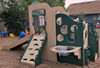 Strictly For Kids Deluxe Challenger 25 Wave Style Playground Structure, Natural or Bright, playground structure with slides, climbing panels, and a tunnel in an outdoor play area.