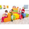 Moje Bambino Rainbow Train Soft Foam Climber Set, colorful foam train playground with four children playing and holding toys indoors.
