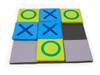 Moje Bambino Giant Tic Tac Toe Floor Game, large colorful foam tic tac toe game with blue X's and green O's on a padded black and gray playing surface.