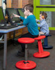 Playscapes Active Learning Wobble Stool, 18¾"H, being used by children sitting at computer desks in a classroom or learning center.