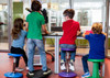 Playscapes Active Learning Wobble Stool, 12H, in use by children at a learning table in a classroom setting.