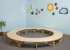 Playscapes Reading Retreat Bench, circular wooden bench with multiple seating sections arranged in a circle in a colorful classroom or playroom setting.