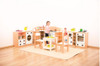 Moje Bambino Toy Washing Machine, child playing with toy kitchen set in a playroom.