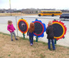 Infinity Playgrounds Chalkboard Flowers - Daisy, Rose or Sunflower, children drawing on flower-shaped chalkboards behind a fence in an outdoor playground area.